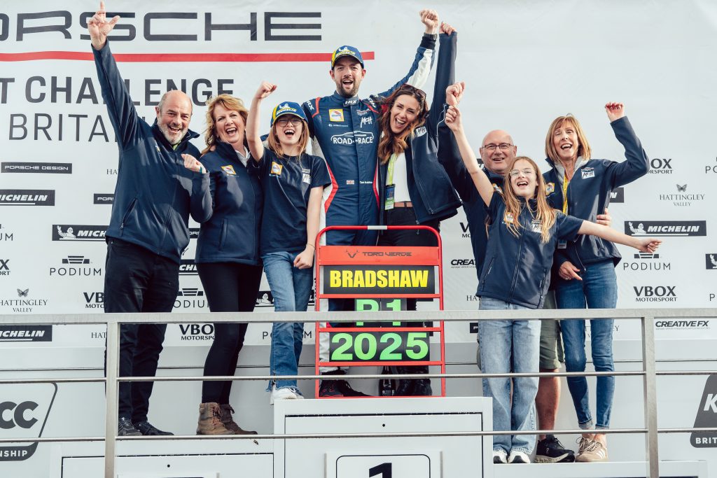 Tom Bradshaw and family standing on the podium at Brands Hatch celebrating his winning the Porsche Sprint Challenge GB Championship 2025